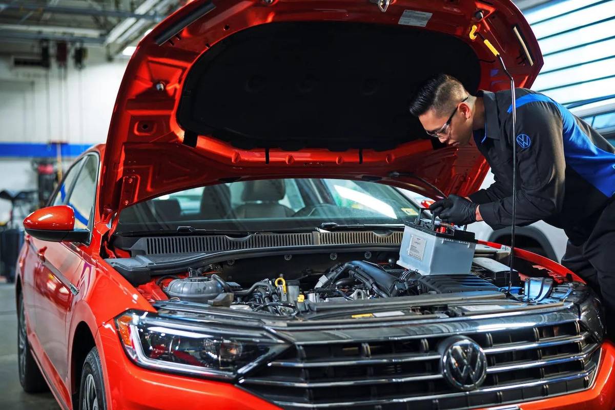 Volkswagen technician installing a battery at Platinum Volkswagen in Hicksville